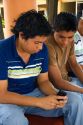 Mexican college students look at images on a cell phone on the campus of Universidad Autonoma de Guerro located in Acapulco, Guerrero, Mexico.