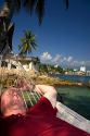 American tourist napping in a hammock on Island Roqueta, Acapulco, Guerrero, Mexico.