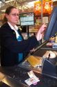 Cashier scanning items and coupons in the checkout line of a supermarket in Idaho, USA.