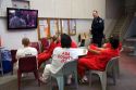 Inmates watch television in the recreational area of a county jail.