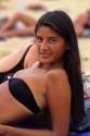Chilean girl sunbathing on the beach at Vina del Mar, Chile.