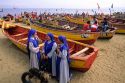 Nuns stand on the beach in front of fishing boats at Valparaiso, Chile.