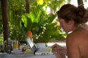 Woman using a laptop computer at a resort near Samara, Costa Rica.