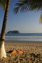 Woman sunbathing on the beach at Playa Samara, Costa Rica.