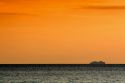 Cruise ship in the pacific ocean at sunset off the coast of Jaco, Costa Rica.