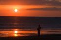 Person walking on the beach at sunset in the Manuel Antonio National Park in Puntarenas province, Costa Rica.