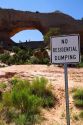 Sign at Wilson Arch,  a natural sandstone arch along U.S. Route 191 near Moab, Utah, USA.