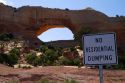Sign at Wilson Arch,  a natural sandstone arch along U.S. Route 191 near Moab, Utah, USA.