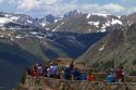 Tourists view the Rocky Mountains from a scenic overlook in the Rocky Mountain National Park, Colorado, USA.