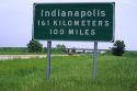 Road sign showing distance in kilometers and miles along Interstate 70 near Indianapolis, Indiana, USA.