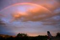 A couple viewing a rainbow at sunset in Boise, Idaho, USA.