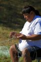 Yakama Nation indian repairing fishing nets at Celilo Village on the Columbia River, Oregon, USA. MR