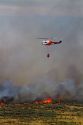 Helicopter with water bucket performing aerial firefighting on a wildfire in Eagle, Idaho, USA.