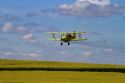 Crop duster spraying pesticide on a corn crop near Jerome, Idaho, USA.