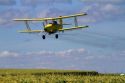 Crop duster spraying pesticide on a corn crop near Jerome, Idaho, USA.
