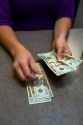 Bank teller counting american dollars at a bank in Boise, Idaho, USA. MR