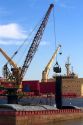 Crane loading a barge with coal on the Mississippi River at New Orleans, Louisiana, USA.