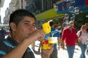 Argentine man blowing bubbles with a Bart Simpson toy along the pedestrian section of Florida Street in the Retiro barrio of Buenos Aires, Argentina.