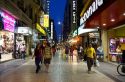 People walking on Lavalle Street at night in Buenos Aires, Argentina.