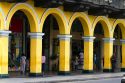 Yellow porticos lead to the entrance of the Plaza Mayor or Plaza de Armas of Lima, Peru.