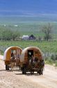 Covered wagons being pulled by mules at the City of Rocks National Reserve and state park in Cassia County, Idaho, USA.