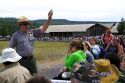 Park ranger giving a tour group information about Old Faithful geyser in Yellowstone National Park, Wyoming, USA.