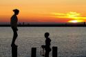 People watch the sunset on Lake Michigan at Pere Marquette Harbor located in Ludington, Michigan, USA.