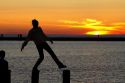 People watch the sunset on Lake Michigan at Pere Marquette Harbor located in Ludington, Michigan, USA.