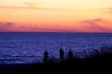 People watch the sunset on Lake Michigan at Pere Marquette Harbor located in Ludington, Michigan, USA.