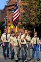 Boy Scout honor guard walking in the Trailing of the Sheep Parade on Main Street in Ketchum, Idaho, USA.