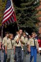 Boy Scout honor guard walking in the Trailing of the Sheep Parade on Main Street in Ketchum, Idaho, USA.