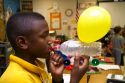 Student blowing up a balloon as part of a science experiment in a fourh grade classroom at a public elementary school in Brandon, Florida, USA.