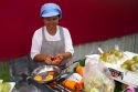 Street vendor cutting fresh fruit in Bangkok, Thailand.