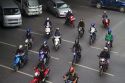 A group of scooters in traffic, Bangkok, Thailand.
