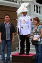 Tourists pose for a picture with a guard wearing a white uniform at The Grand Palace in Bangkok, Thailand.