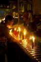 Woman lighting a candle at the Shwedagon Paya located in (Rangoon)Yangon, (Burma) Myanmar.