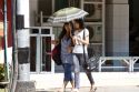 Burmese girls walk together under the shade of an umbrella in (Rangoon) Yangon, (Burma) Myanmar.