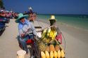 Vendors selling fruit at Chaweng beach and the Gulf of Thailand on the island of Ko Samui, Thailand.