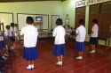 Thai elementary students dance with direction from a television at school on the island of Ko Samui, Thailand.