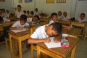 Thai elementary school students sit a desks on the island of Ko Samui, Thailand.