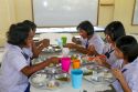 Thai elementary school students eat lunch on the island of Ko Samui, Thailand.