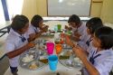 Thai elementary school students eat lunch on the island of Ko Samui, Thailand.