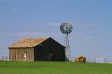 Barn and windmill on farmland near Dalhart, Texas, USA.