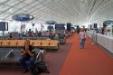 Travelers in a waiting room at Charles de Gaulle Airport, Paris, France.