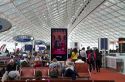 Travelers in a waiting room at Charles de Gaulle Airport, Paris, France.