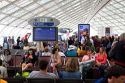 Travelers in a waiting room at Charles de Gaulle Airport, Paris, France.