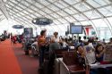 Travelers in a waiting room at Charles de Gaulle Airport, Paris, France.