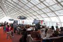 Travelers in a waiting room at Charles de Gaulle Airport, Paris, France.