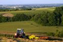 Tractor baling hay west of Angouleme in southwestern France.