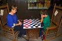 Grandmother and grandson play a game of checkers at a Cracker Barrel in Brandon, Florida, USA.